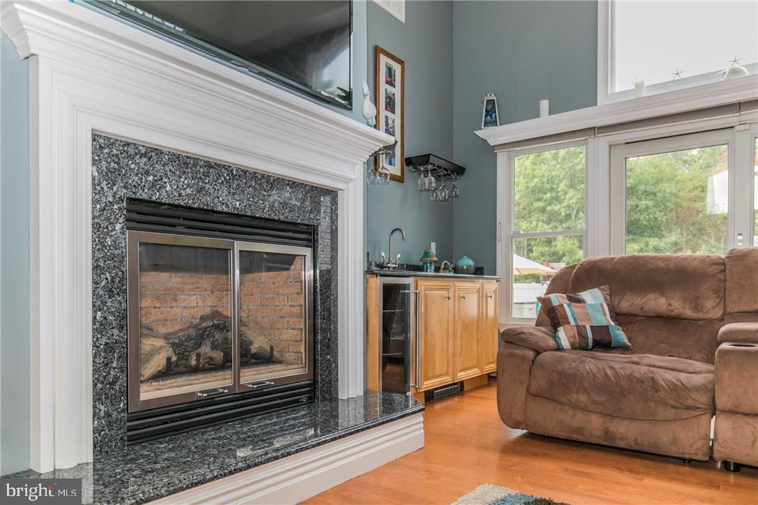 39 Harbor Inn Road Bayville, NJ 08721 - Photo 11 of 27 a living room with furniture and a fireplace