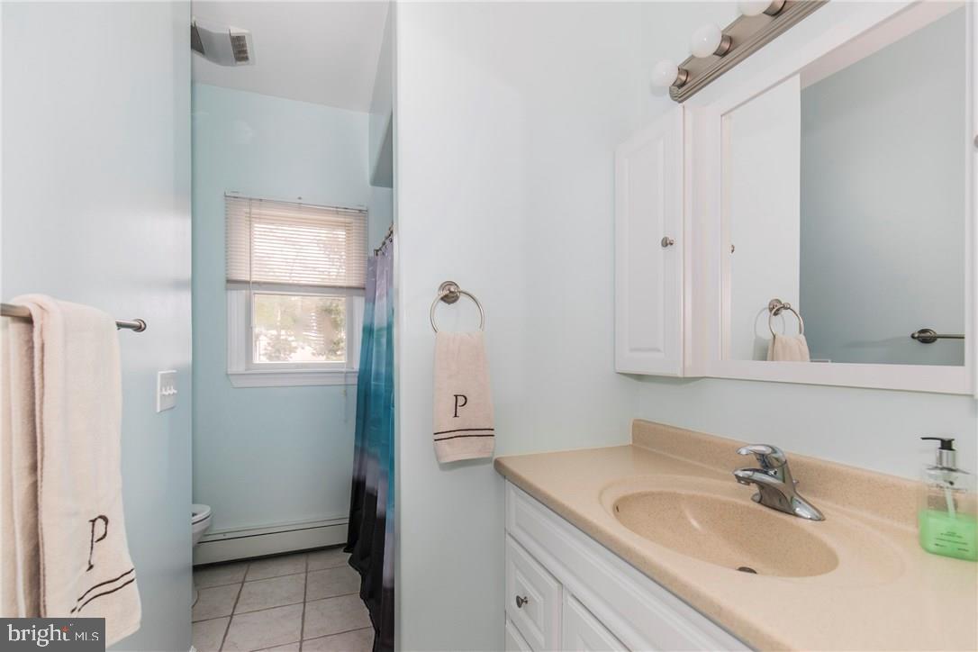 39 Harbor Inn Road Bayville, NJ 08721 - Photo 16 of 27 a bathroom with a sink and a mirror