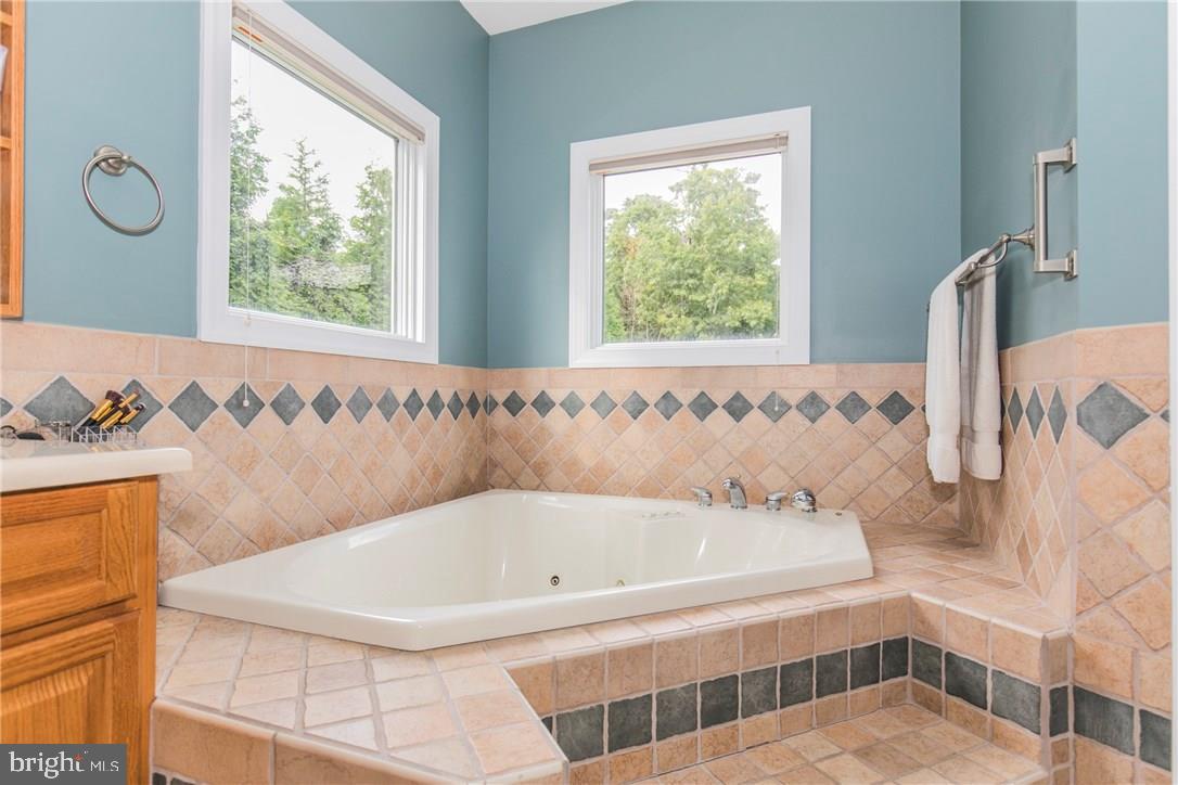 39 Harbor Inn Road Bayville, NJ 08721 - Photo 18 of 27 a bathroom with a bathtub and a window