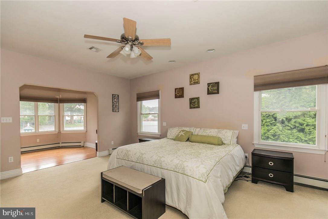 39 Harbor Inn Road Bayville, NJ 08721 - Photo 21 of 27 a bedroom with a bed and a large window