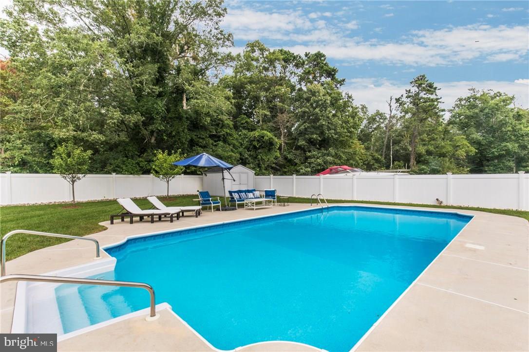 39 Harbor Inn Road Bayville, NJ 08721 - Photo 24 of 27 a view of a swimming pool with chairs