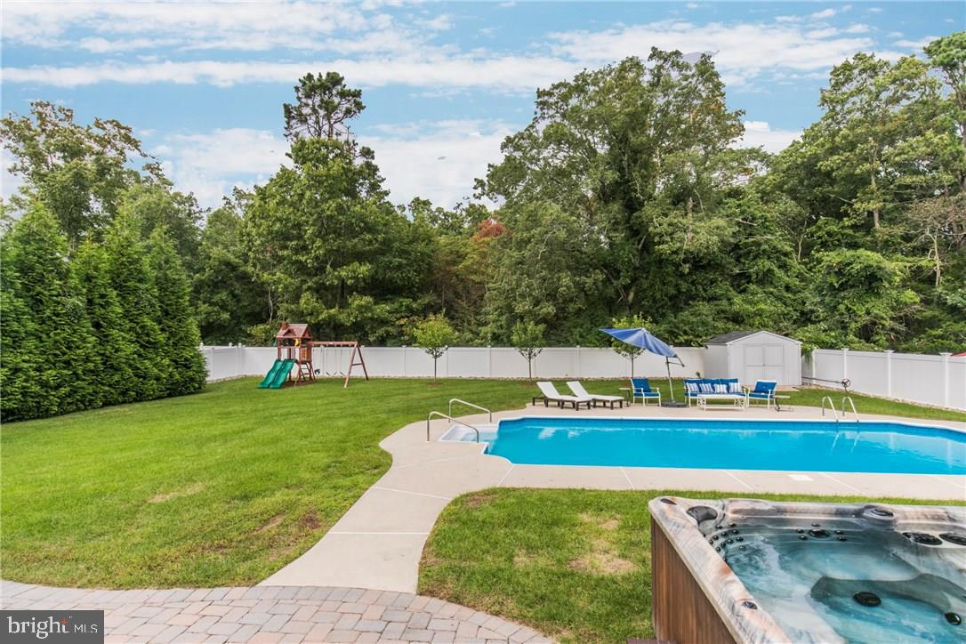 39 Harbor Inn Road Bayville, NJ 08721 - Photo 25 of 27 a view of a swimming pool with a garden