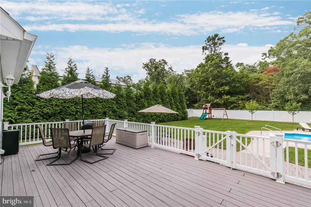 39 Harbor Inn Road Bayville, NJ 08721 - Photo 26 of 27 a view of a deck with furniture and garden