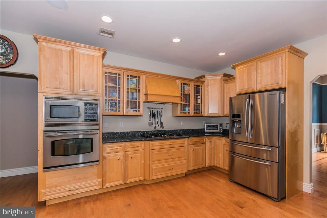 39 Harbor Inn Road Bayville, NJ 08721 - Photo 7 of 27 a kitchen with granite countertop stainless steel appliances and wooden cabinets
