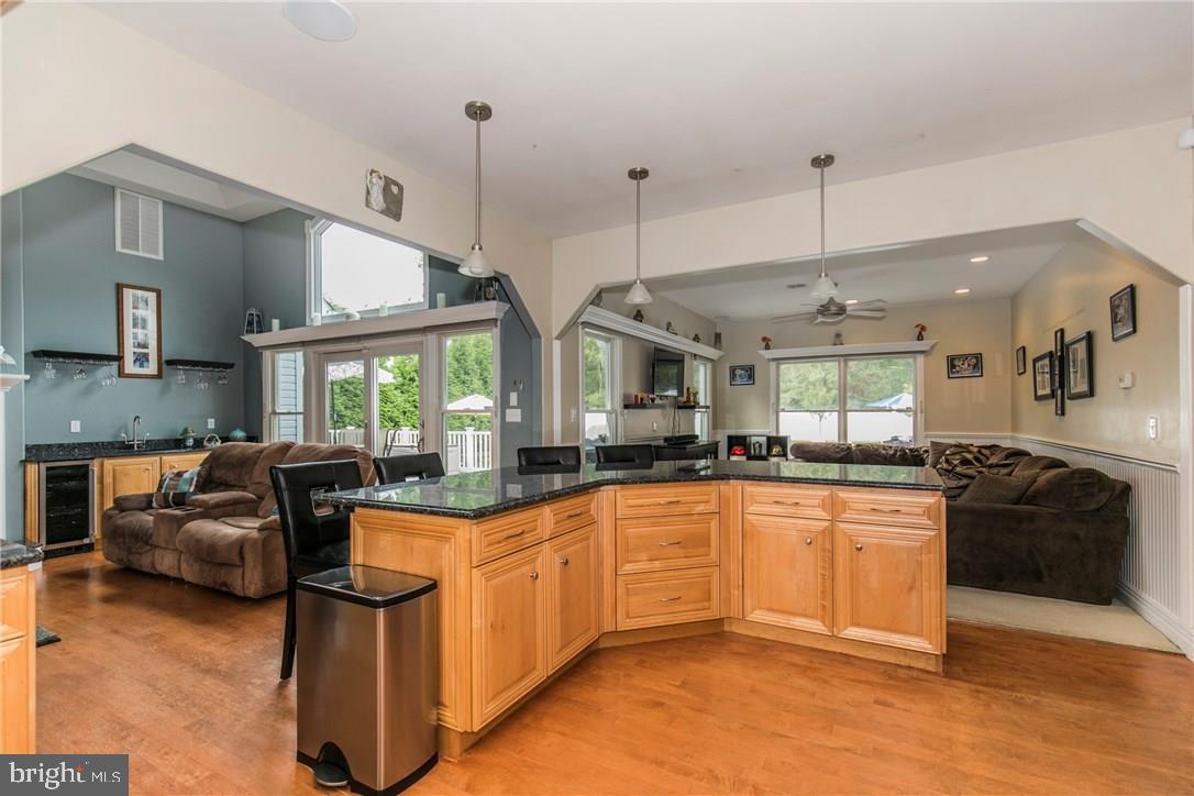 39 Harbor Inn Road Bayville, NJ 08721 - Photo 8 of 27 a kitchen with stainless steel appliances granite countertop a stove and a view of living room