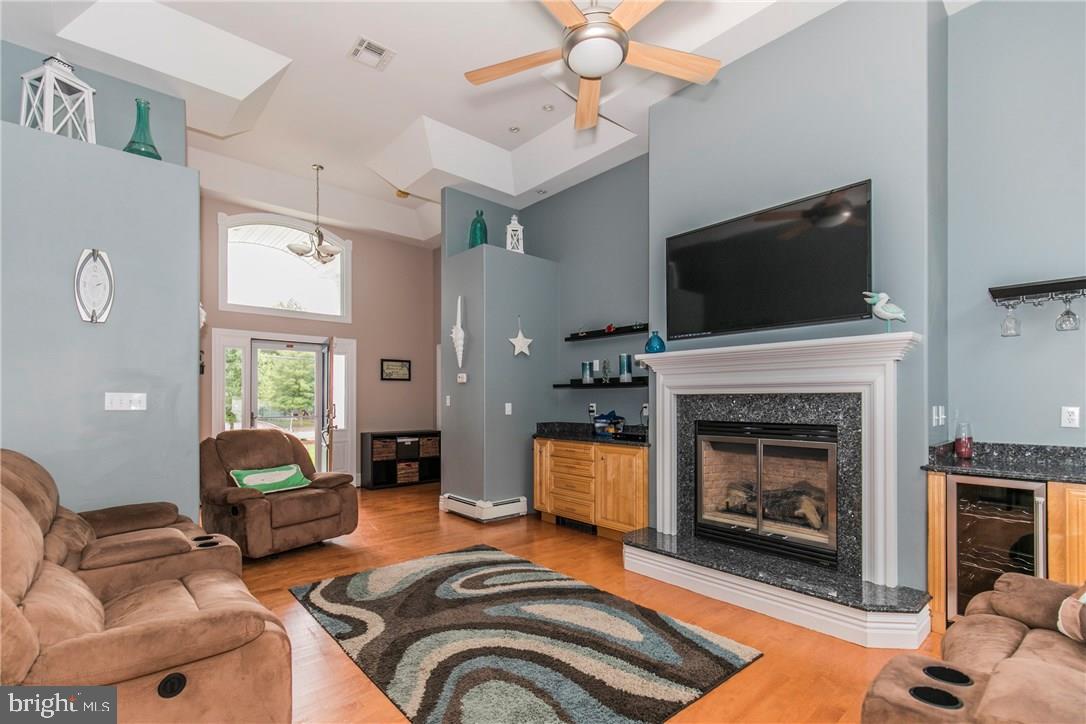 39 Harbor Inn Road Bayville, NJ 08721 - Photo 10 of 27 a living room with furniture and a fireplace