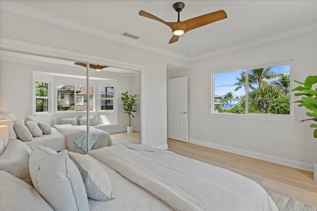 a bedroom with furniture and a large window