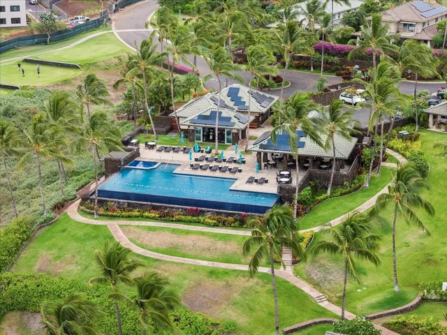 an aerial view of a house with swimming pool garden and patio