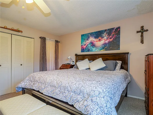 a bedroom with a bed and cupboard