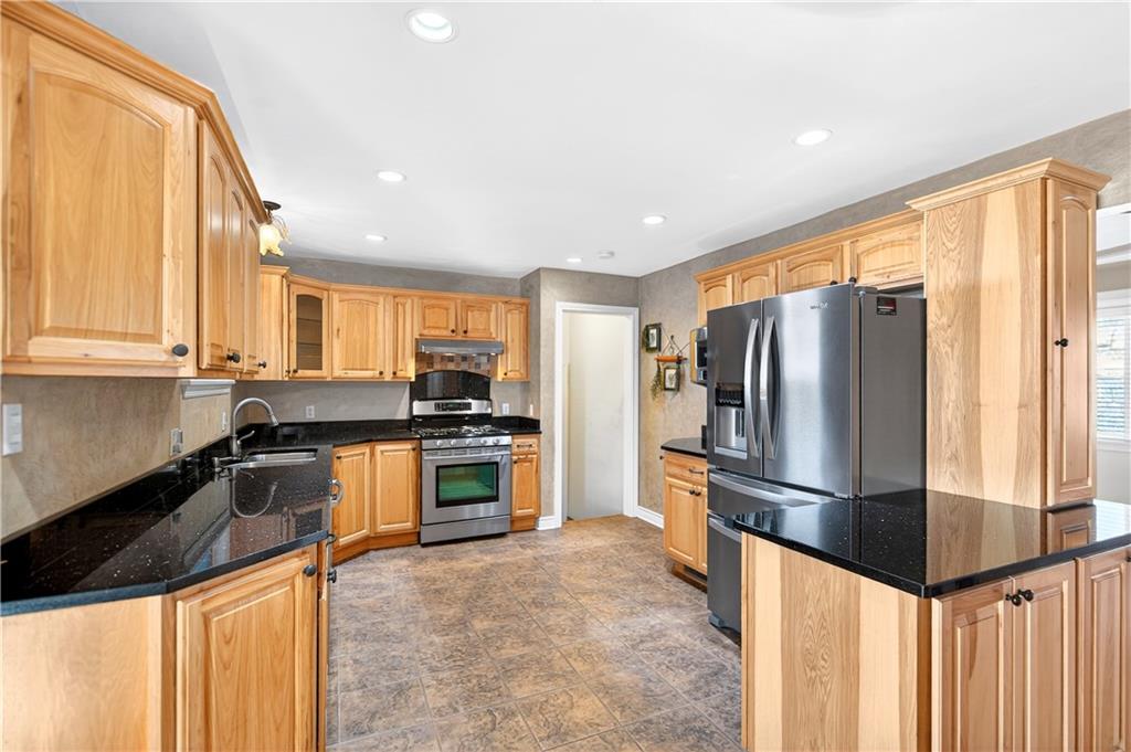 1238 Georges Station Road Greensburg, PA 15601 - Photo 11 of 50 The updated kitchen highlights granite counters and stainless steel appliances with additional counter space and pantry.