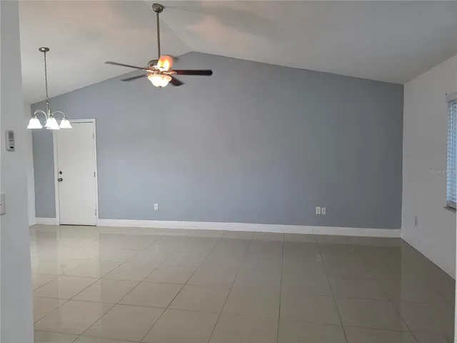 a view of a chandelier fan and wooden floor