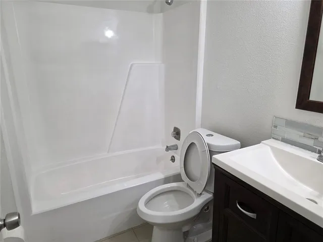 a bathroom with a sink a toilet and a bathtub