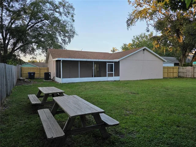 a backyard of a house with table and chairs