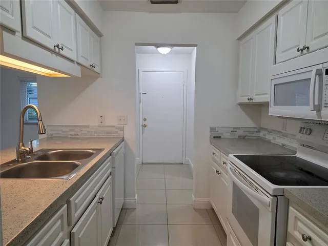 a kitchen with a sink stove and cabinets