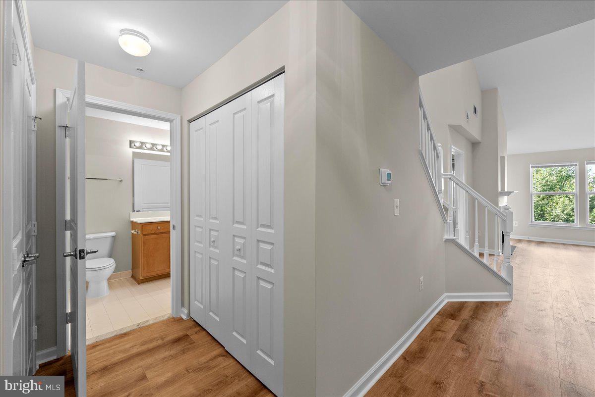 12000 Market Street, Unit 469 Reston, VA 20190 - Photo 13 of 41 a view of a hallway with wooden floor and staircase