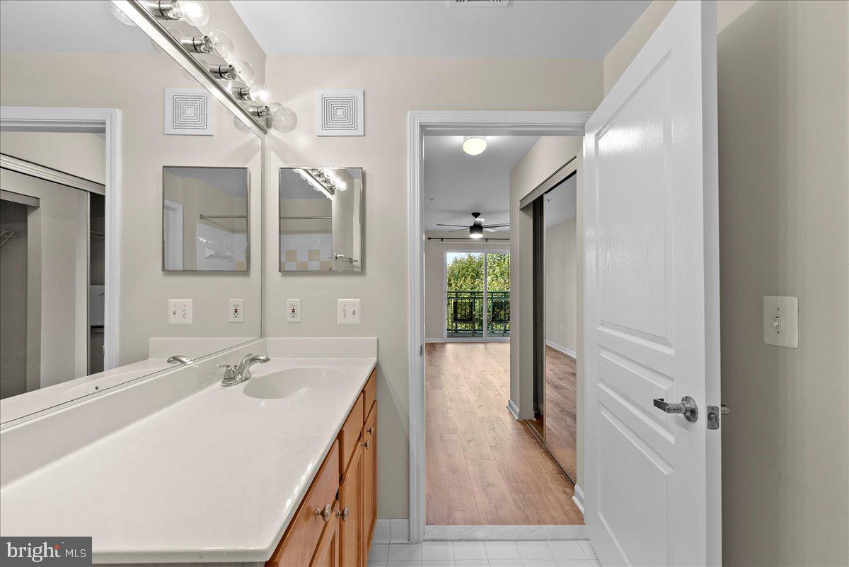 12000 Market Street, Unit 469 Reston, VA 20190 - Photo 14 of 41 a spacious bathroom with a double vanity sink and a mirror