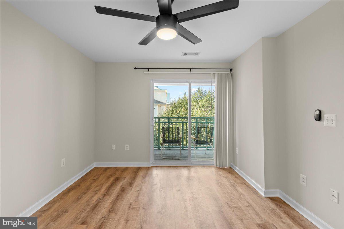 12000 Market Street, Unit 469 Reston, VA 20190 - Photo 16 of 41 a view of empty room with wooden floor and fan