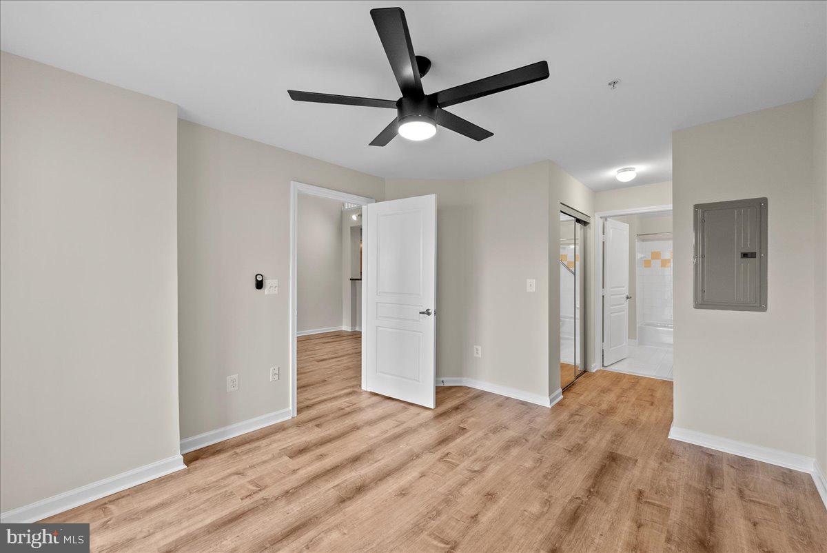 12000 Market Street, Unit 469 Reston, VA 20190 - Photo 19 of 41 a view of a livingroom with a ceiling fan wooden floor and a ceiling fan
