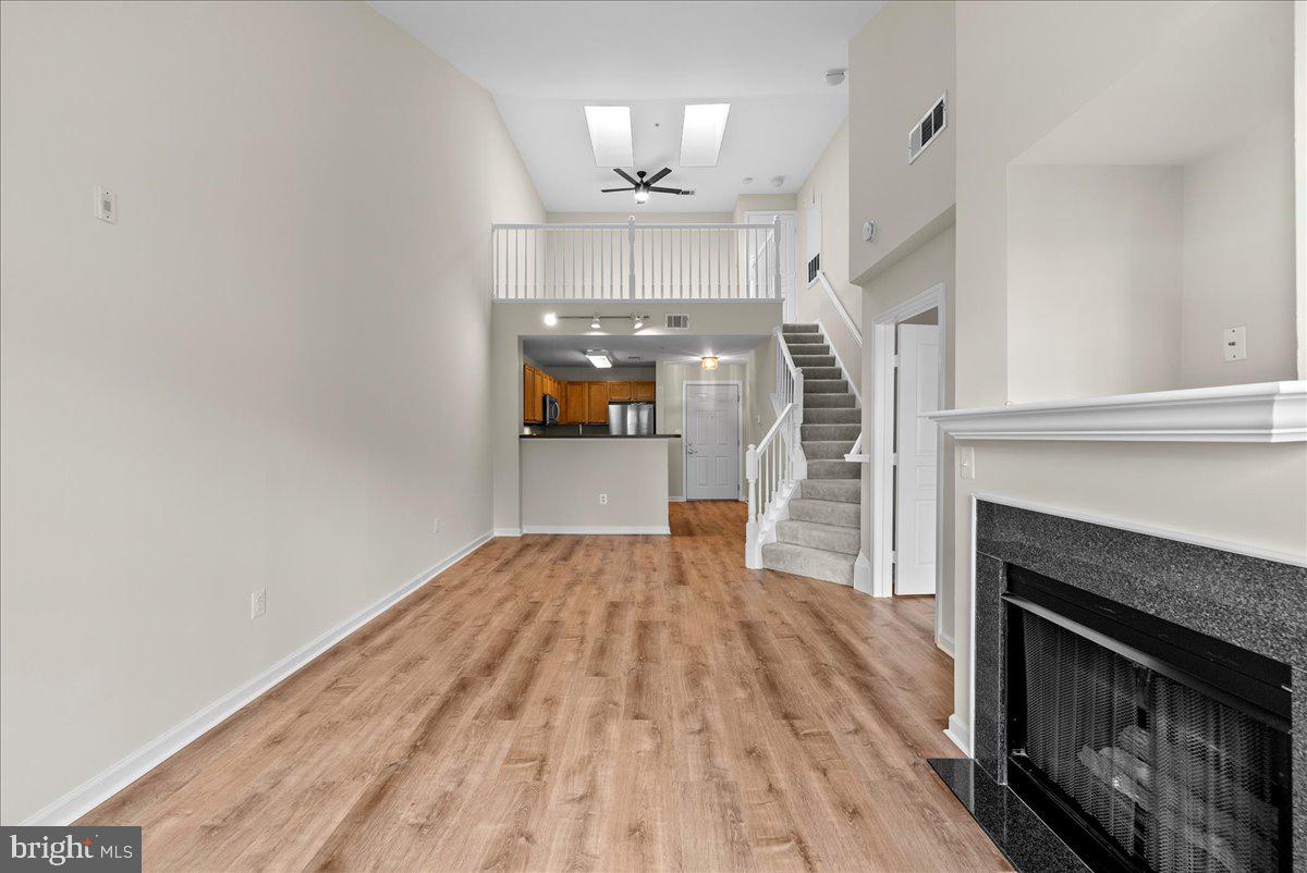 12000 Market Street, Unit 469 Reston, VA 20190 - Photo 2 of 41 a view of empty room with wooden floor and fireplace