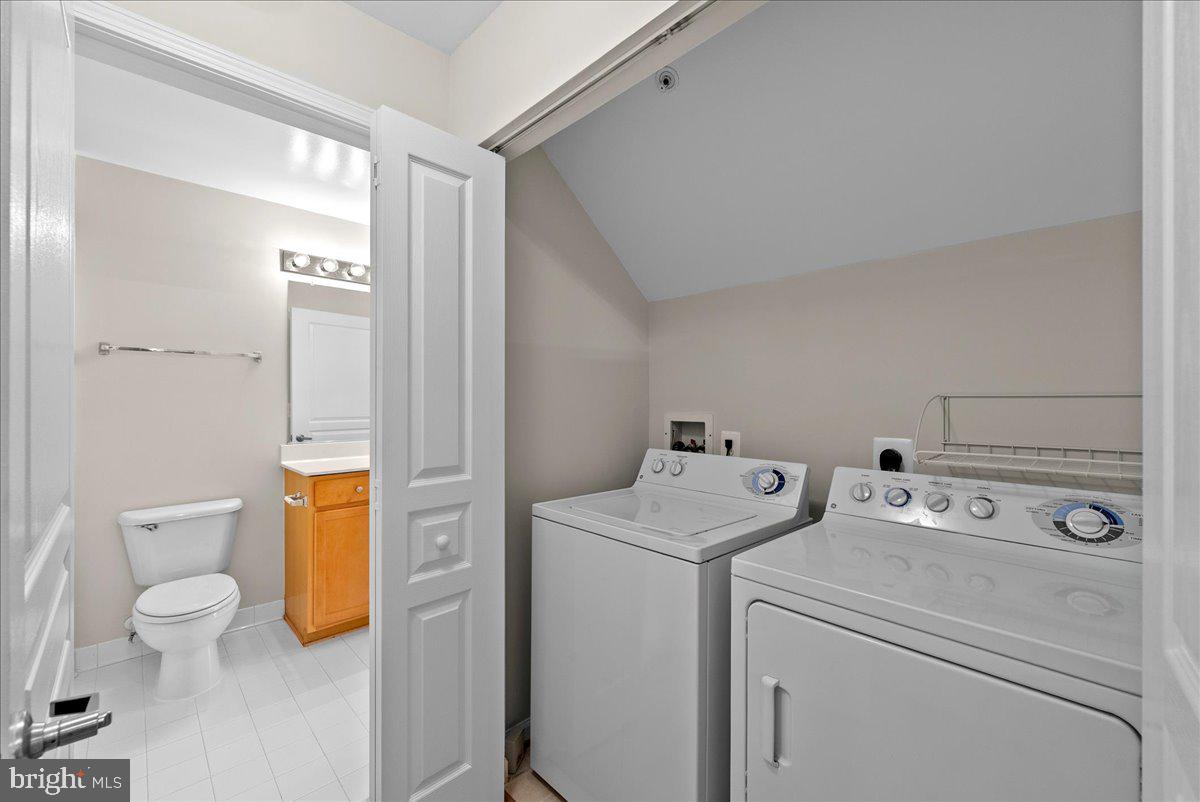12000 Market Street, Unit 469 Reston, VA 20190 - Photo 21 of 41 a view of bathroom with a washer and dryer