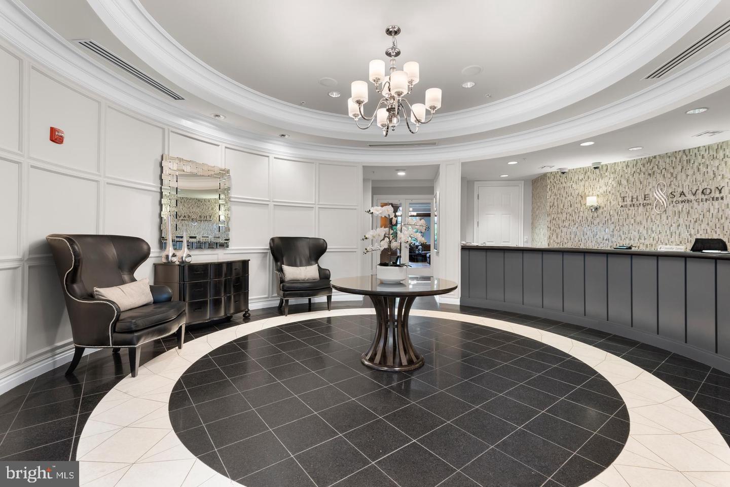 12000 Market Street, Unit 469 Reston, VA 20190 - Photo 23 of 41 a living room with furniture a chandelier and a rug