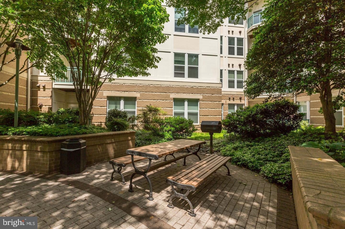 12000 Market Street, Unit 469 Reston, VA 20190 - Photo 24 of 41 a view of backyard of house with outdoor seating and green space