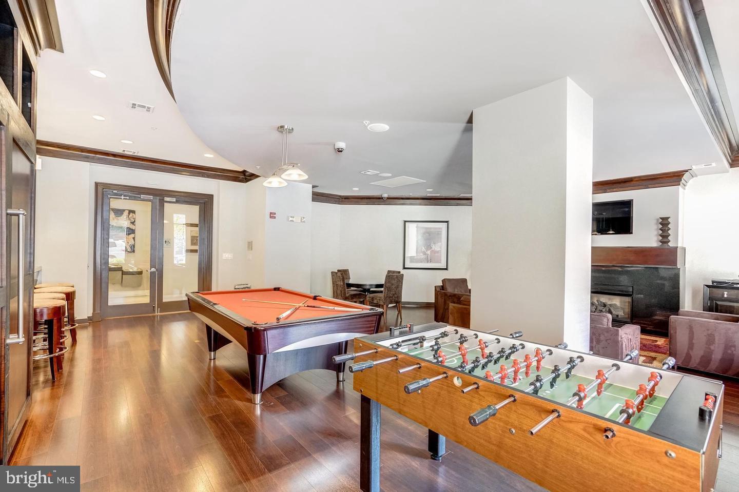 12000 Market Street, Unit 469 Reston, VA 20190 - Photo 35 of 41 a living room with furniture a dining table and chairs with wooden floor