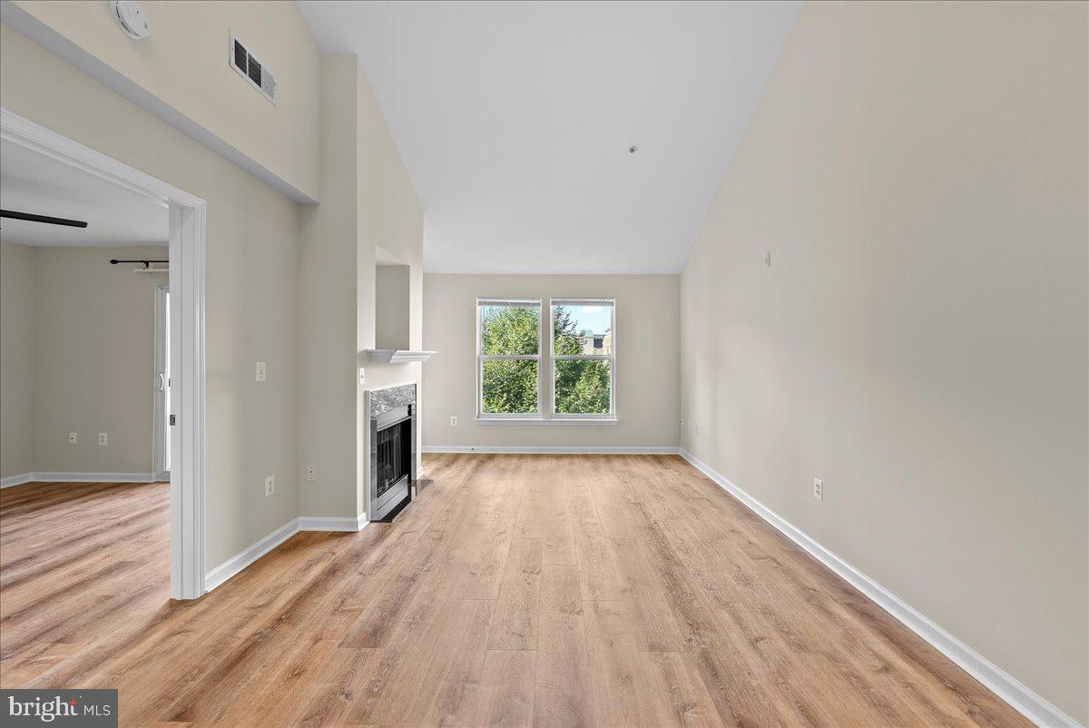 12000 Market Street, Unit 469 Reston, VA 20190 - Photo 5 of 41 wooden floor in an empty room with a window