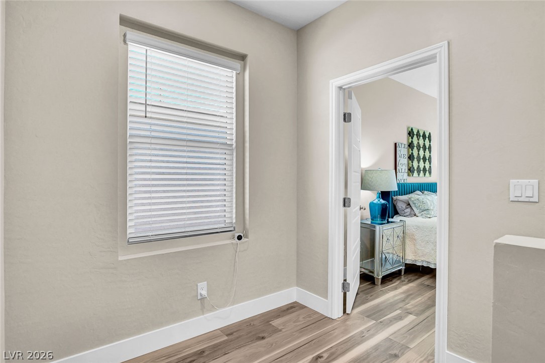 9688 Rankin Rdg Court Las Vegas, NV 89178 - Photo 26 of 53 Hardwood flooring extends throughout this transitional space leading into a private bedroom.