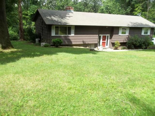 43 Greenbrier Road Trumbull, CT 06611 - Photo 1 of 1 a front view of a house with a yard and garage