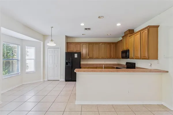 a kitchen with stainless steel appliances granite countertop a refrigerator stove and sink