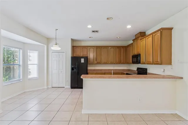 a kitchen with stainless steel appliances granite countertop a refrigerator stove and sink
