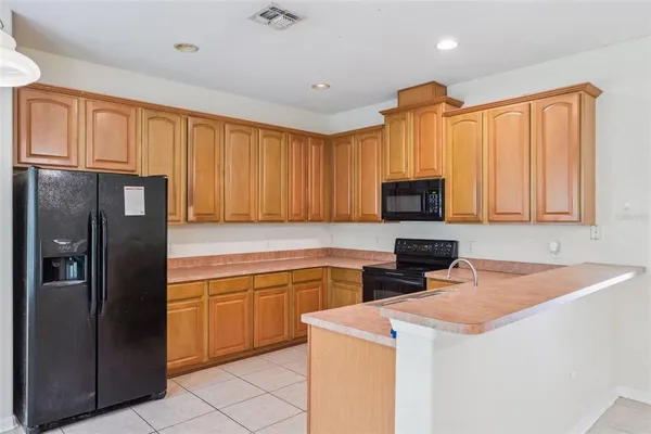 an empty room with an entryway and fan
