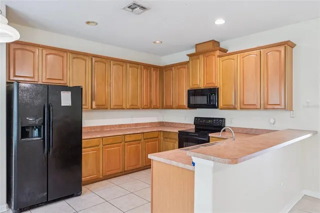 an empty room with an entryway and fan
