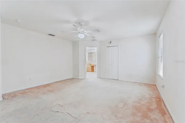 an empty room with windows and closet
