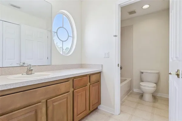 a bathroom with a sink toilet vanity and shower