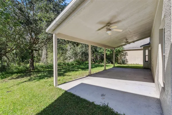 a view of a house with a yard and sitting area