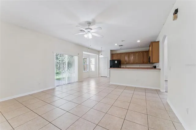 a view of a kitchen with a sink and dishwasher a refrigerator with white cabinets