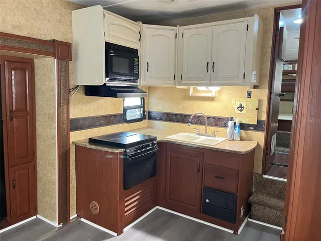 a kitchen with stainless steel appliances granite countertop a stove and a microwave