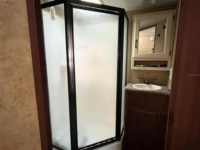 a bathroom with a glass shower door