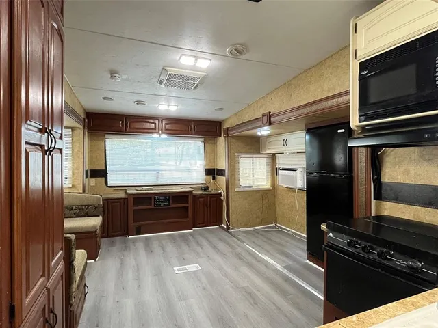 a large kitchen with stainless steel appliances and large counter top