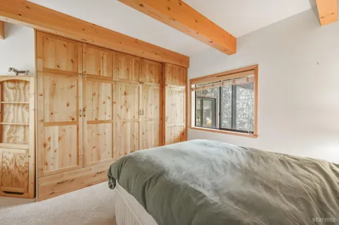 a bed sitting in a bedroom next to a window