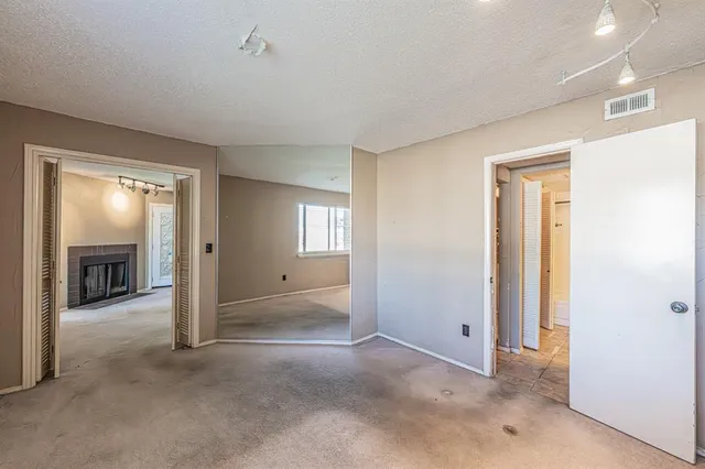 an empty room with windows and bathroom view