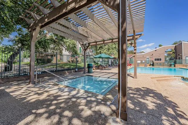 a view of a patio with a table chairs and wooden fence