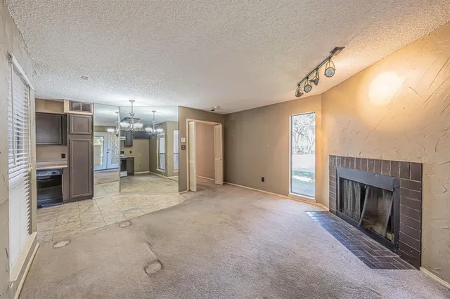 a view of a livingroom with a fireplace and a window