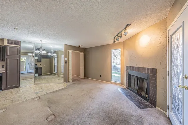 a view of a livingroom with a fireplace and window