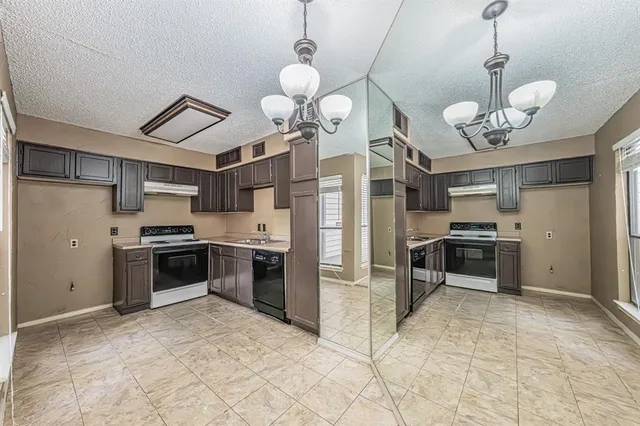 a kitchen with cabinets and stainless steel appliances