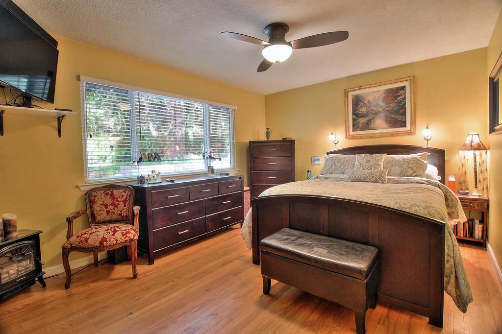 180 Locust Lane Ben Lomond, CA 95005 - Photo 14 of 33 a bedroom with a bed and wooden floor