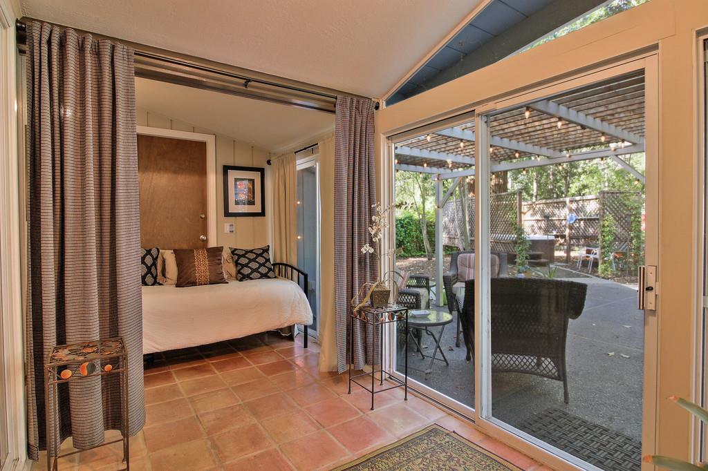 180 Locust Lane Ben Lomond, CA 95005 - Photo 18 of 33 a bed room with a bed and glass door