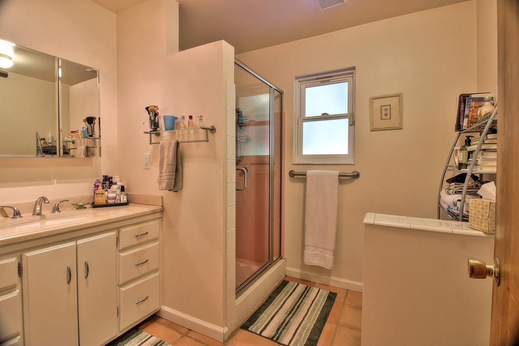 180 Locust Lane Ben Lomond, CA 95005 - Photo 19 of 33 a bathroom with a sink a mirror a vanity and a shower